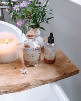 A wooden tray adorned with candles and flowers, creating a serene and elegant ambiance.