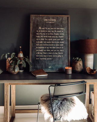 A notebook, pen, and book placed on a wooden table, creating a serene and organized workspace.