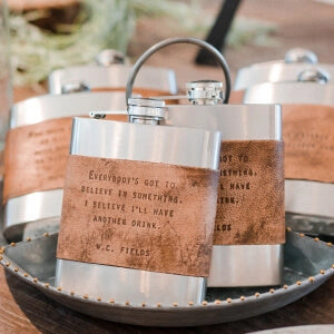 a group of flasks with leather bands