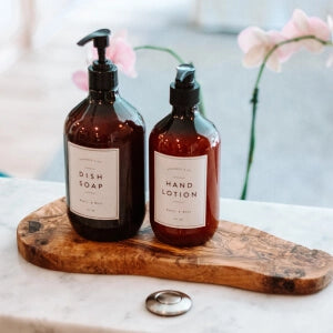 a couple of bottles of liquid on a wood tray